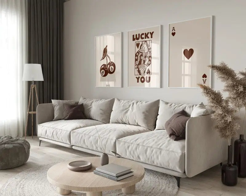 Beige upholstered sectional sofa with dark brown throw pillows beside decorbites™ retro queen of hearts canvas wall art set