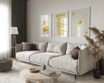 Beige upholstered sectional sofa with dark gray throw pillows next to decorbites™ retro queen of hearts wall art set