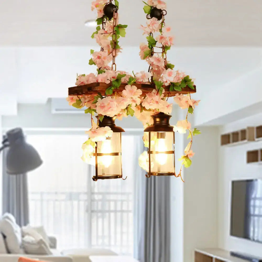 Rustic wooden island ceiling light with pink green floral vines and two vintage lanterns plant flower decor