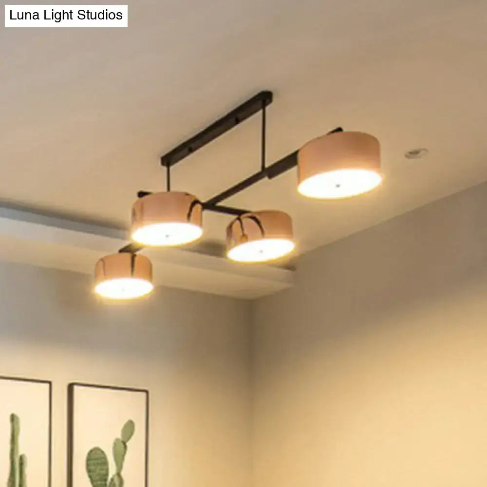 Decorbites rose gold metal 4-light pendant light fixture with four warm cylindrical shades for minimalist dining room