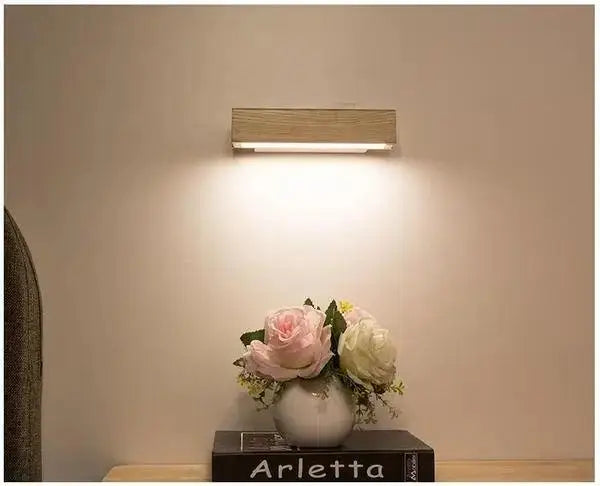 A sleek rectangular wooden wall sconce with warm glow from decorbites™ rotated led modern wall sconces