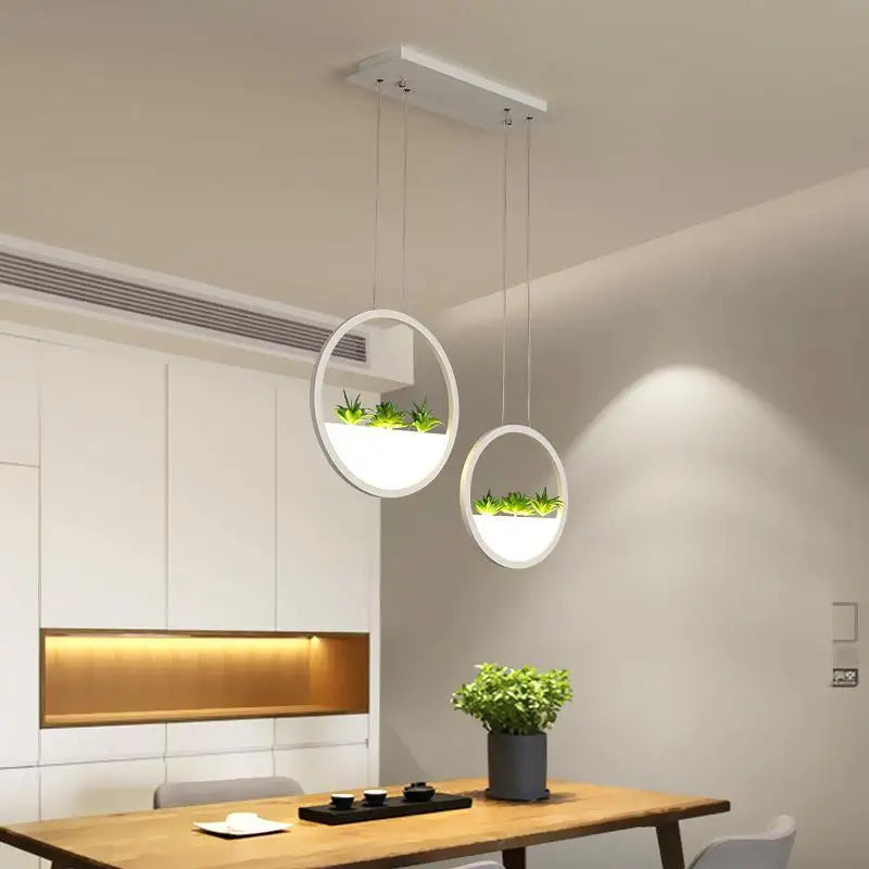 Modern white circular led chandelier with built-in planters holding green succulents by DecorBites™