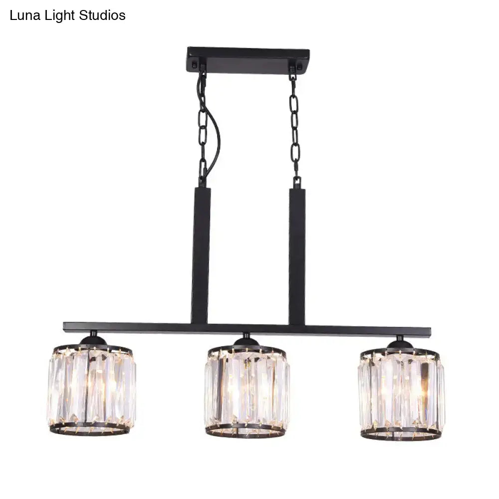 Black metal cylindrical island pendant with three prismatic crystal cylindrical shades ideal for table lighting