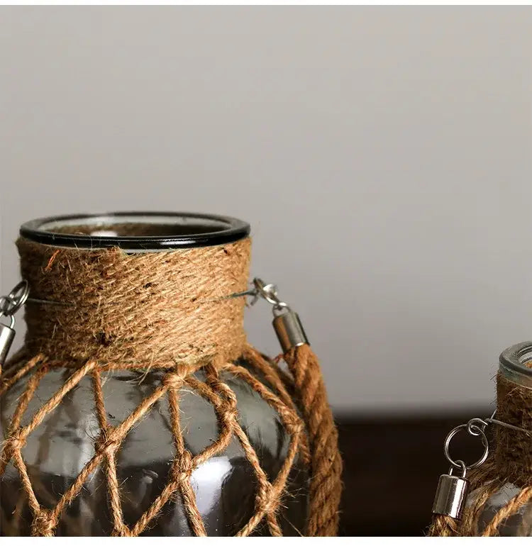 Decorbites™ rustic hanging glass vase with black rim wrapped in brown jute rope and metal clasps for hanging glass use