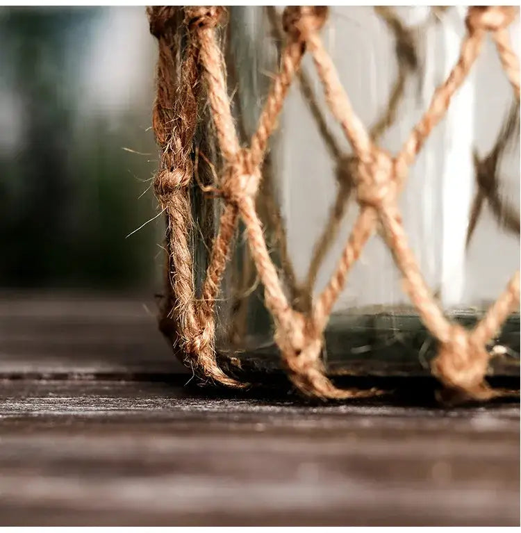 Decorbites™ rustic hanging glass vase with natural hemp rope netting and woven diamond pattern encircling jar base