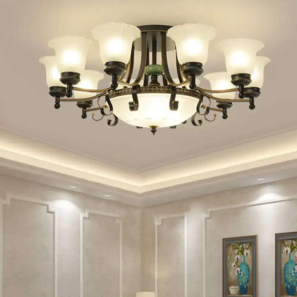 Antique bronze-finished ceiling light fixture with eight frosted glass shades and ornate central design for living room