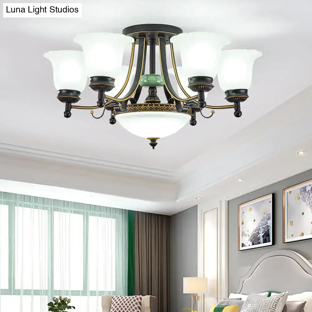 Antique bronze and gold-toned decorbites ceiling light fixture with five frosted glass shades and green ceramic accent