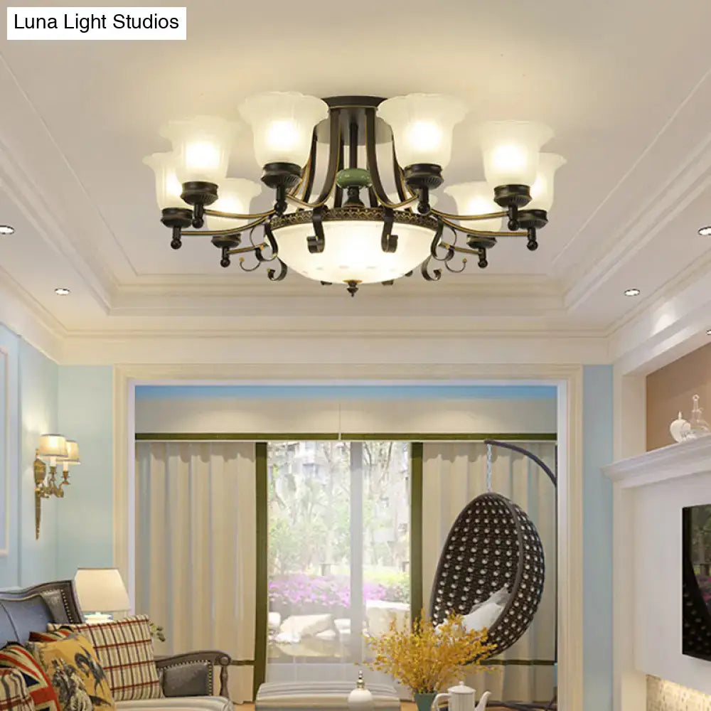 Antique bronze finish ceiling light fixture with eight frosted glass shades and ornate central diffuser for living room
