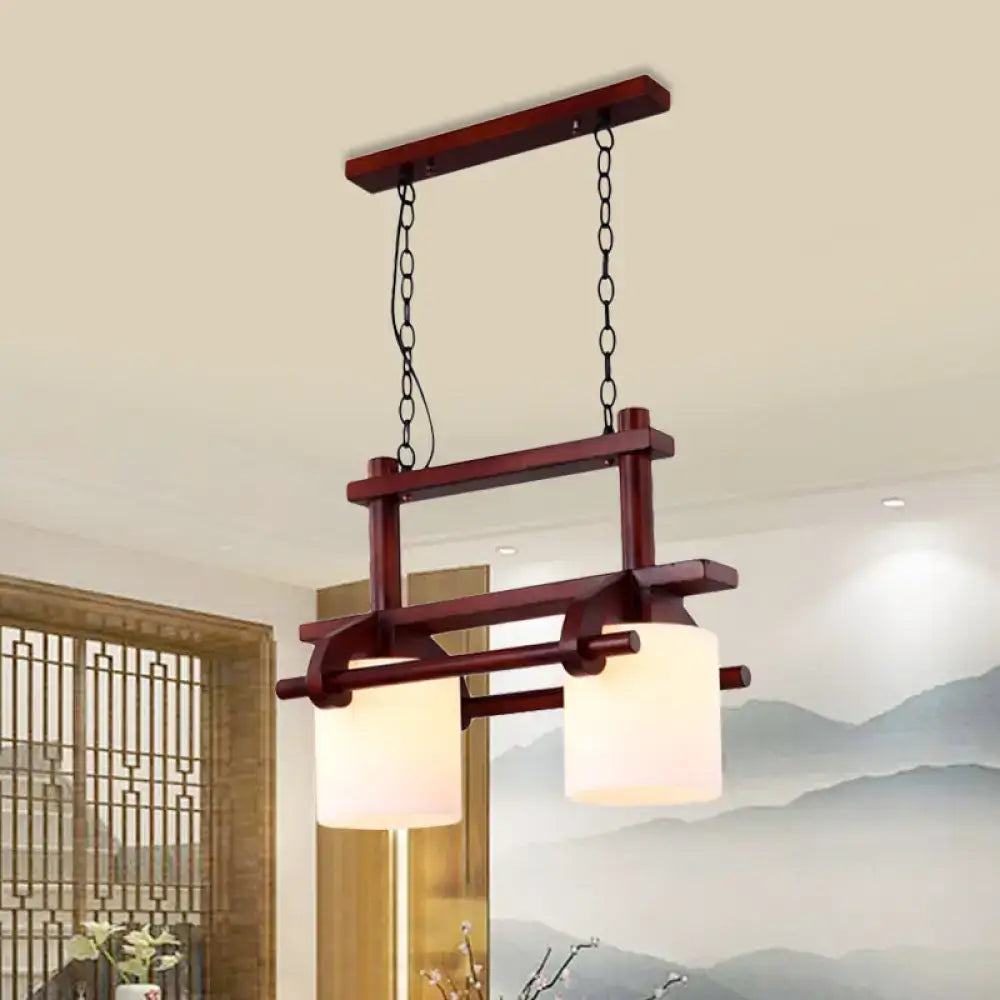 DecorBites™ rustic wooden island light with two white glass shades hanging by black chains for dining room use