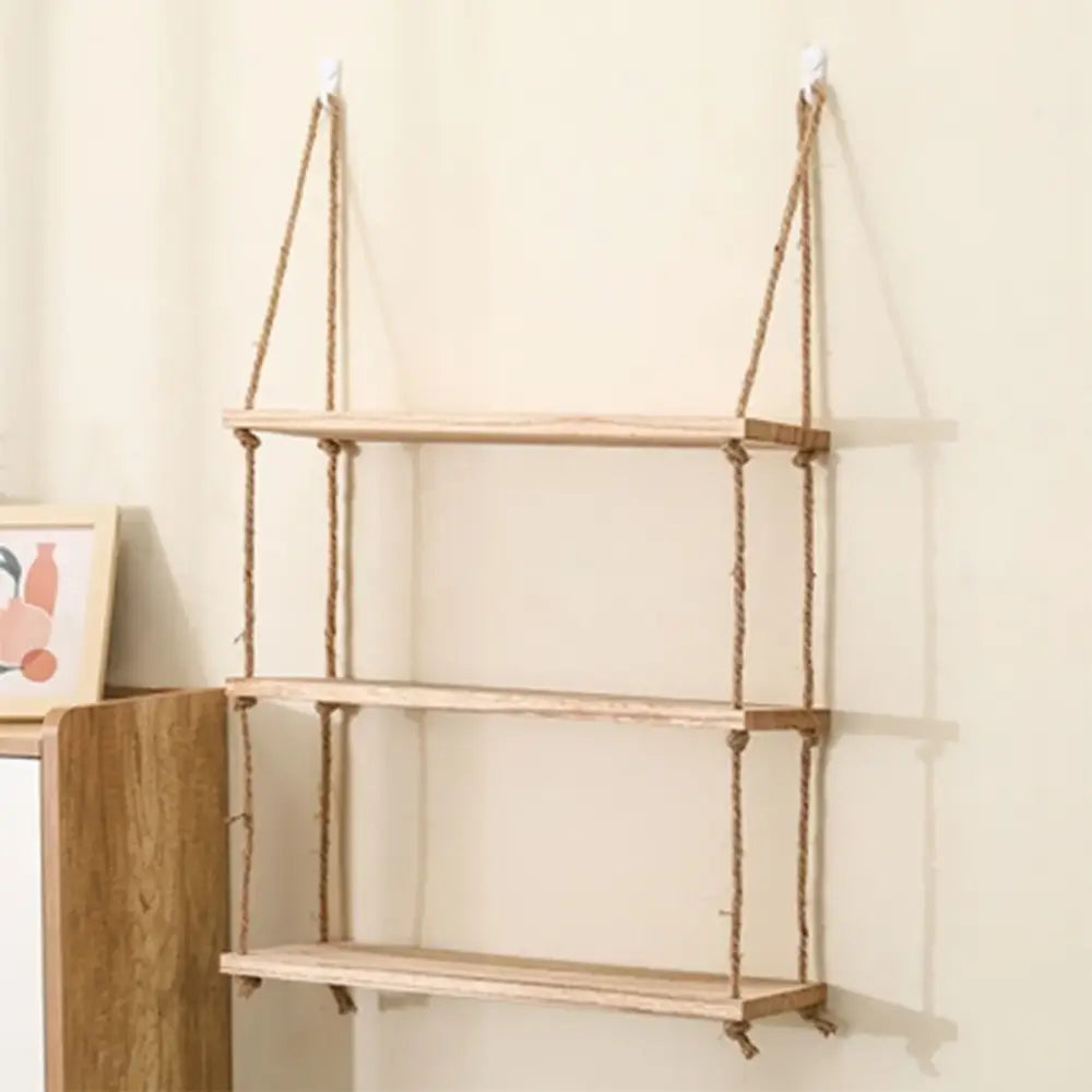 A minimalist set of 3 decorbites rustic wood floating wall shelves with light wood and natural rope suspension