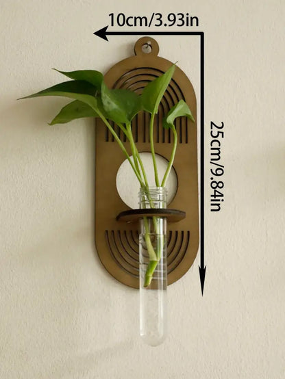 Bronze-colored rustic wood wall vase by decorbites with clear glass test tube holding green leaves for wall greenery