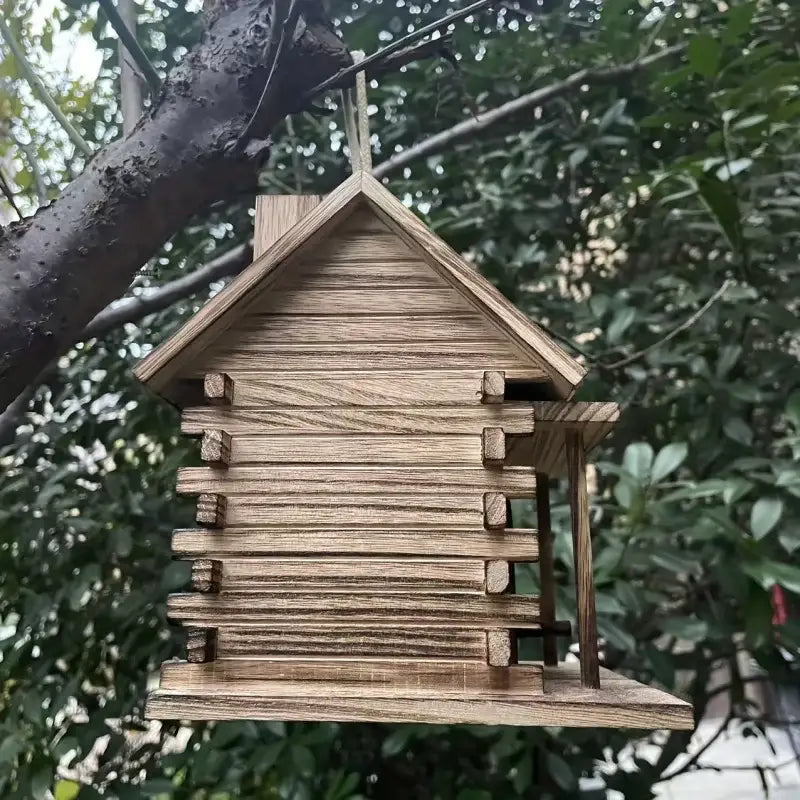 DecorBites™ rustic wooden birdhouse with slanted roof and plank siding hanging from a tree for small birds