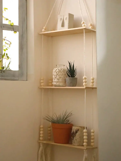 DecorBites rustic wooden wall shelf with three wooden tiers hanging by macrame cords with cream wooden beads