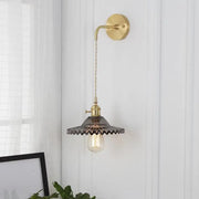 Industrial smoked glass brass sconce light with dark ribbed glass and exposed filament bulb for bedroom use