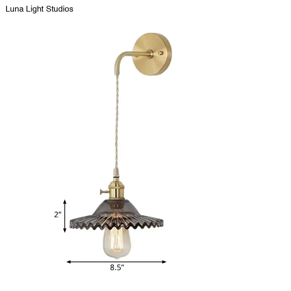Industrial smoked glass brass sconce light with brass finish dark scalloped glass shade and exposed Edison bulb for bedroom