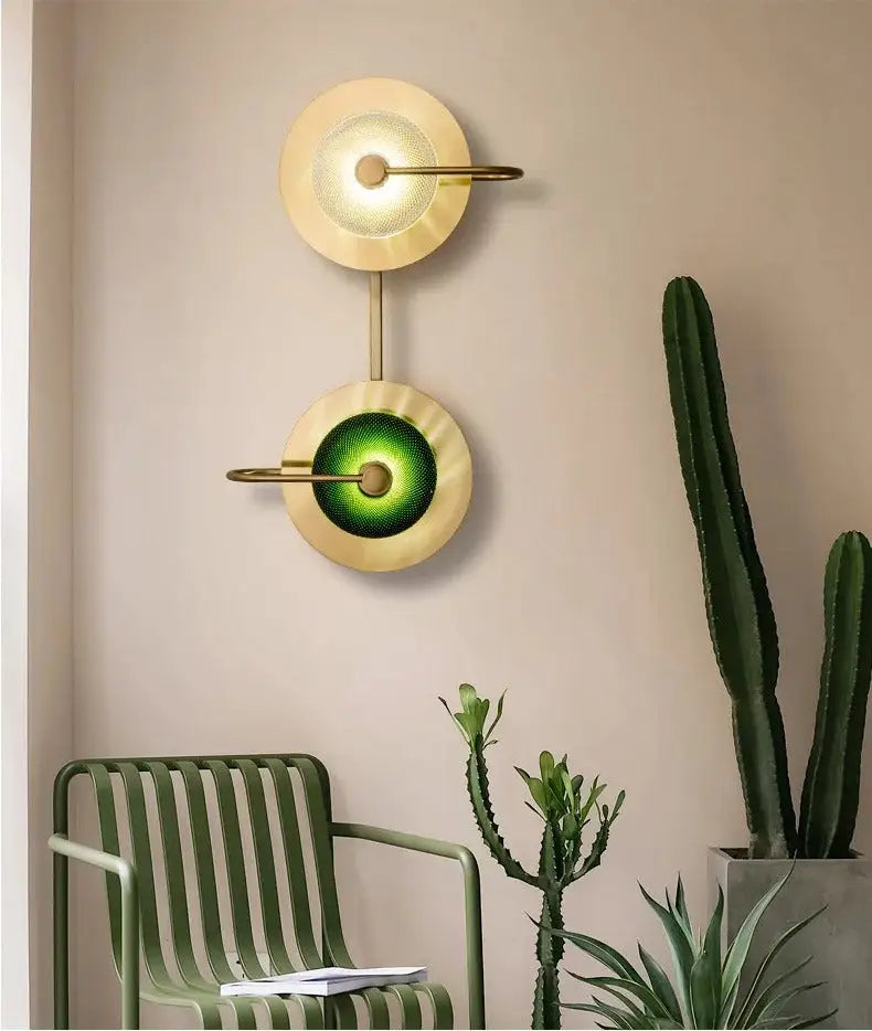 Decorbites™ scandinavian brass wall sconce with premium brass arms and dual circular shades glowing warm yellow and green