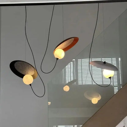 DecorBites™ scandinavian pendant light with sleek matte black and warm copper oval metal shades and glowing bulbs