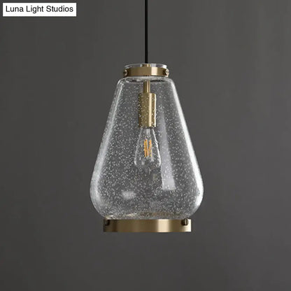 DecorBites™ seeded glass pendant light with speckled texture, brass rim, and exposed filament bulb for bedrooms