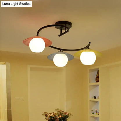 Decorbites semi flush light with black spiral metal arms and coral pink gray yellow glass shades three heads