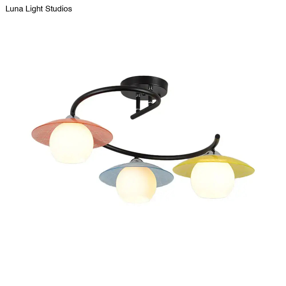 Modern DecorBites semi flush light with black curved metal arms and coral blue yellow saucer shades, three heads