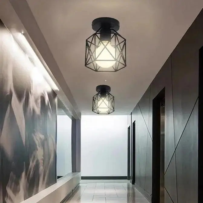 Black geometric metal semi flush mount ceiling light with hexagonal cage design by decorbites
