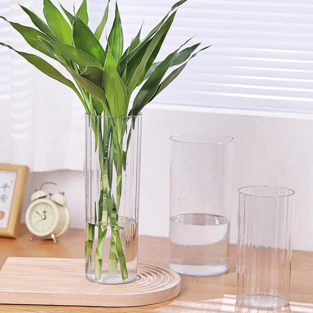 DecorBites™ shatterproof clear acrylic flower vase holding vibrant green bamboo stalks in a clear cylindrical design