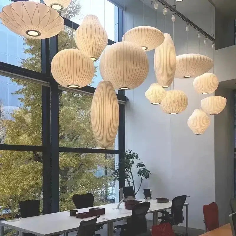 Beige ribbed silk led pendant lamps suspended in modern office space by DecorBites™ modern designer lighting