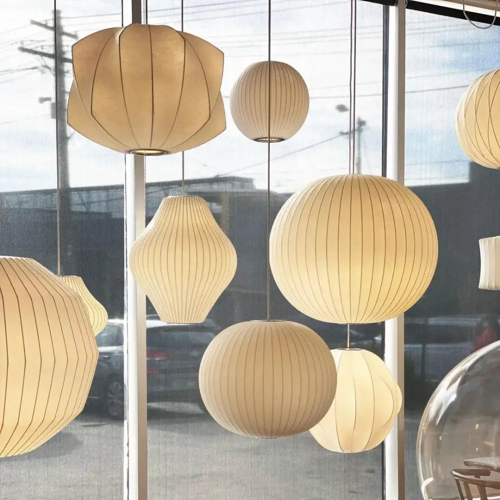 Cream-colored ribbed silk led pendant lamps with modern geometric design hanging from ceiling by decorbites™