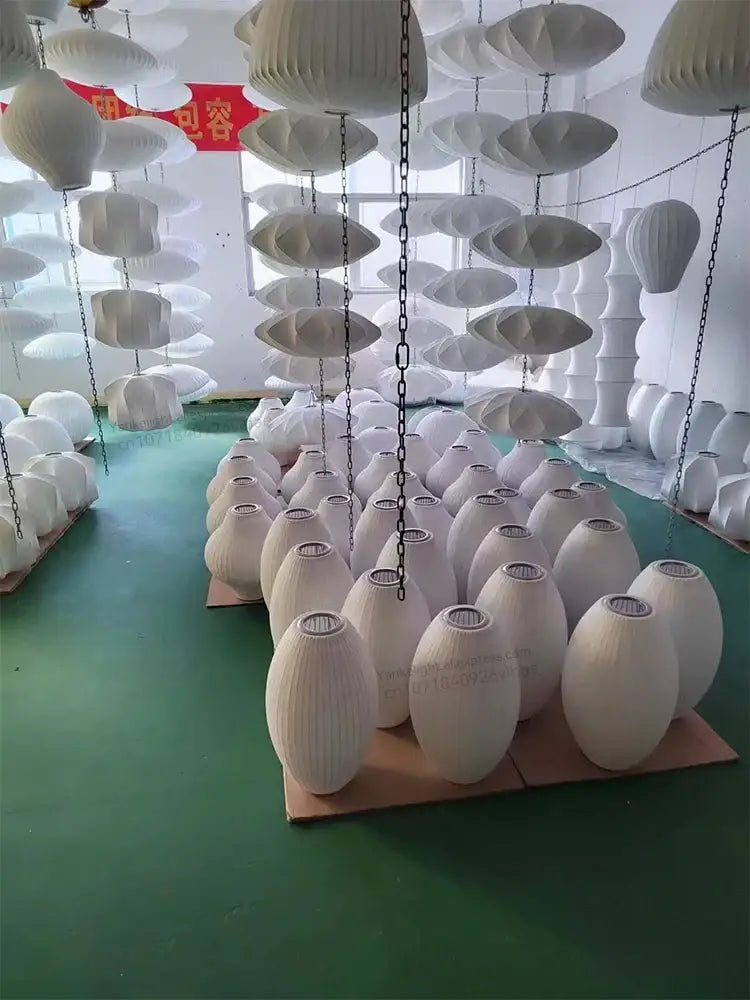 Decorbites™ silk led pendant lamp featuring white ribbed paper egg-shaped shades hanging in an industrial setting