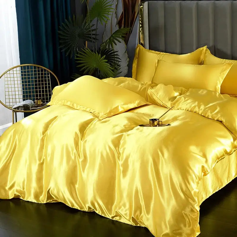 Lustrous golden satin silk luxury bedding set with matching pillows and plush duvet for elegant bedroom decor