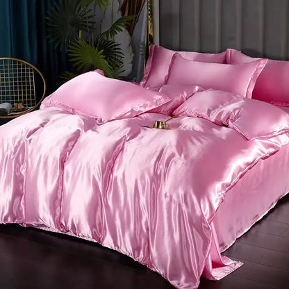 Pink satin silk luxury bedding set with duvet cover and matching pillows featuring a glossy finish