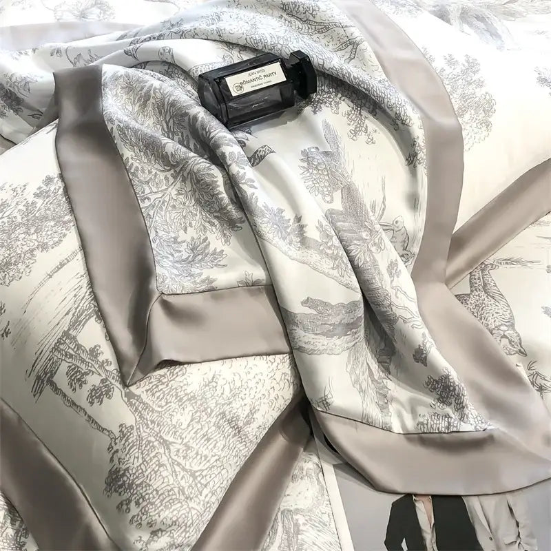A luxurious silver-gray silk scarf with toile pattern and satin trim for the DecorBites eucalyptus fiber duvet cover set