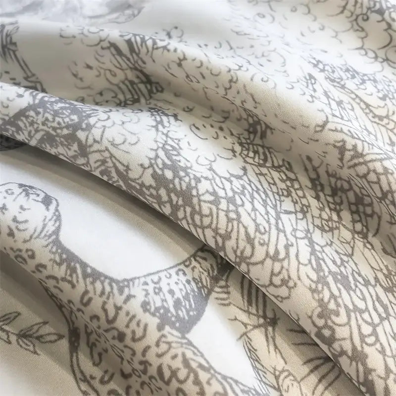 Cream-colored eucalyptus fiber duvet cover with delicate gray leopards hand-drawn for decorbites forest leopard bedding set