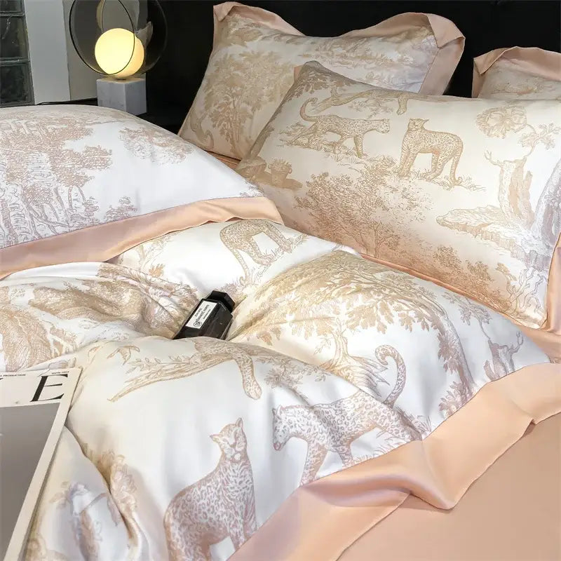 Elegant ivory satin duvet cover and bed sheet set with gold leopard forest motif and peach piping made of eucalyptus fiber