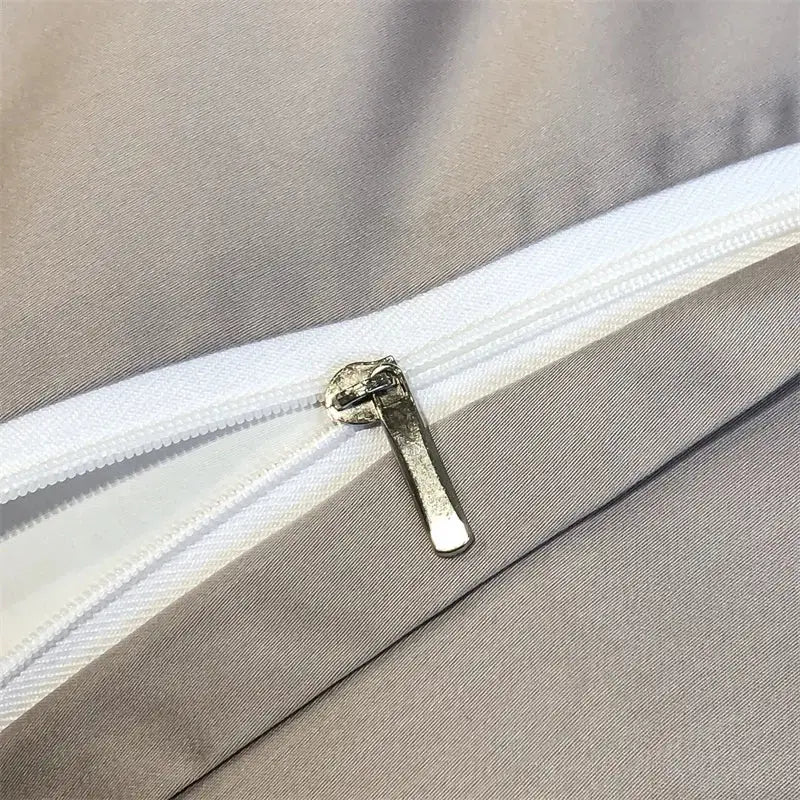 Silver-toned zipper pull on white zipper track of DecorBites™ silky eucalyptus fiber duvet cover with forest leopard print