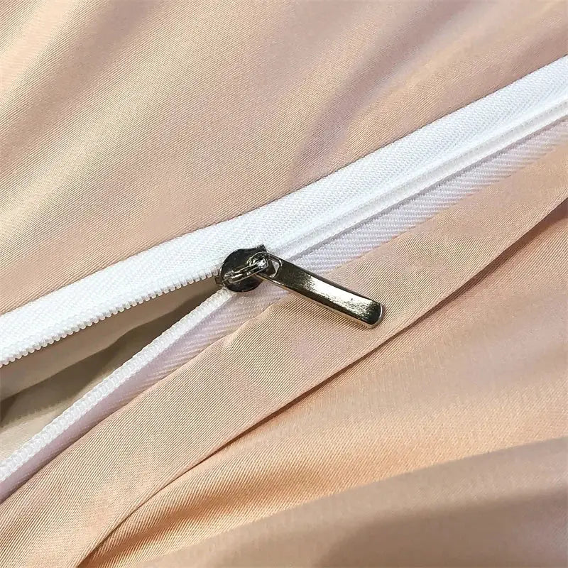 A sleek silver zipper on blush-pink satin eucalyptus fiber duvet cover from decorbites silky eucalyptus fiber bedding set forest leopard