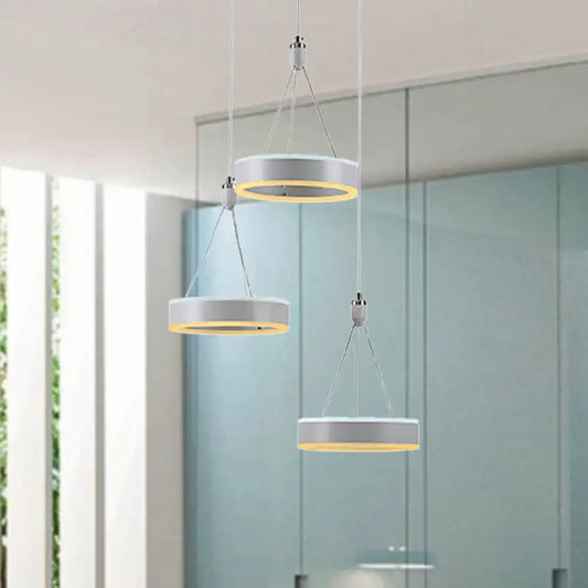 Modern white and silver cluster ceiling light with warm yellow led rings ideal for dining room illumination
