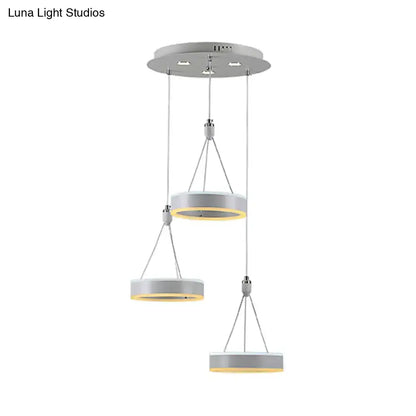 Modern white and silver cluster ceiling light with sleek metallic rings and warm yellow led glow for dining room