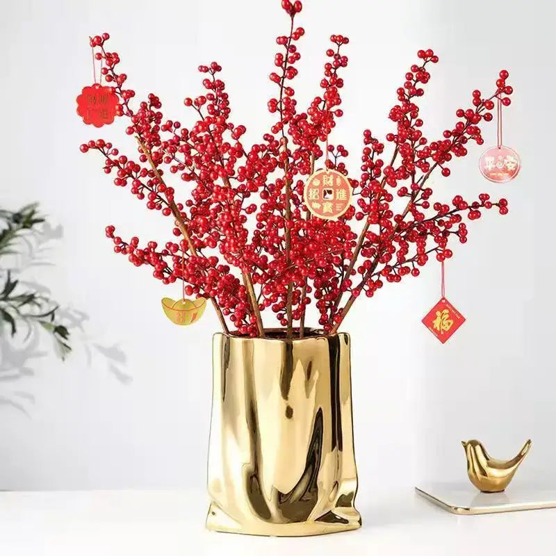 DecorBites™ silver ruffled flower vase in metallic gold with textured bag-like design holding red berry branches