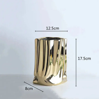 A sleek gold ceramic flower vase with textured ribbed surface and slightly irregular edges from decorbites silver ruffled collection