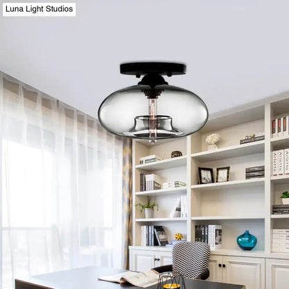 Modern black decorbites flush mount with a sleek glass oval flush shade and exposed filament bulb for hallway lighting