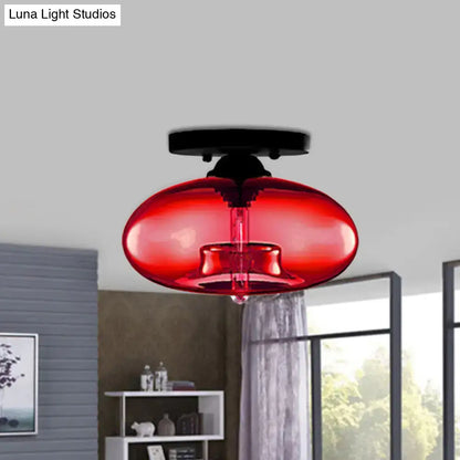 Vibrant red glass oval flush pendant light with sleek black metal ceiling mount from DecorBites flush mount collection