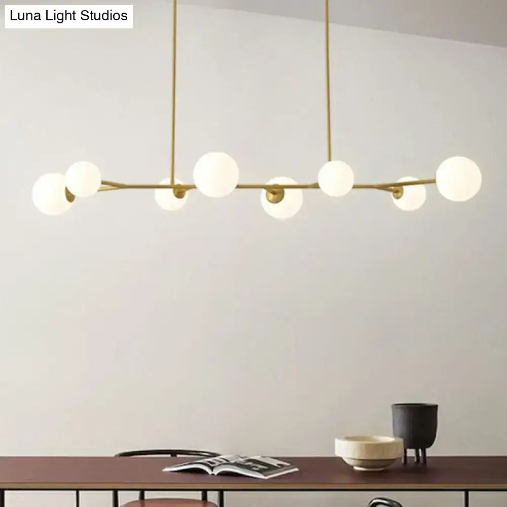 Modern brass molecular island pendant light with frosted opal glass globe bulbs for dining room ceilings