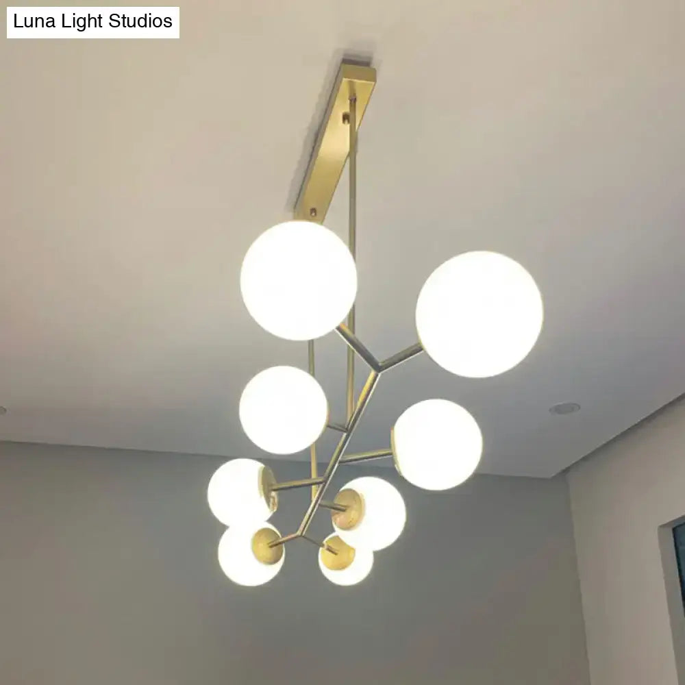 Modern brass-finished DecorBites Simplicity molecular island chandelier with six opal glass globes for dining rooms ceiling