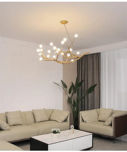 Gold-toned iron tree branch chandelier with antler design and multiple spherical bulbs by DecorBites™