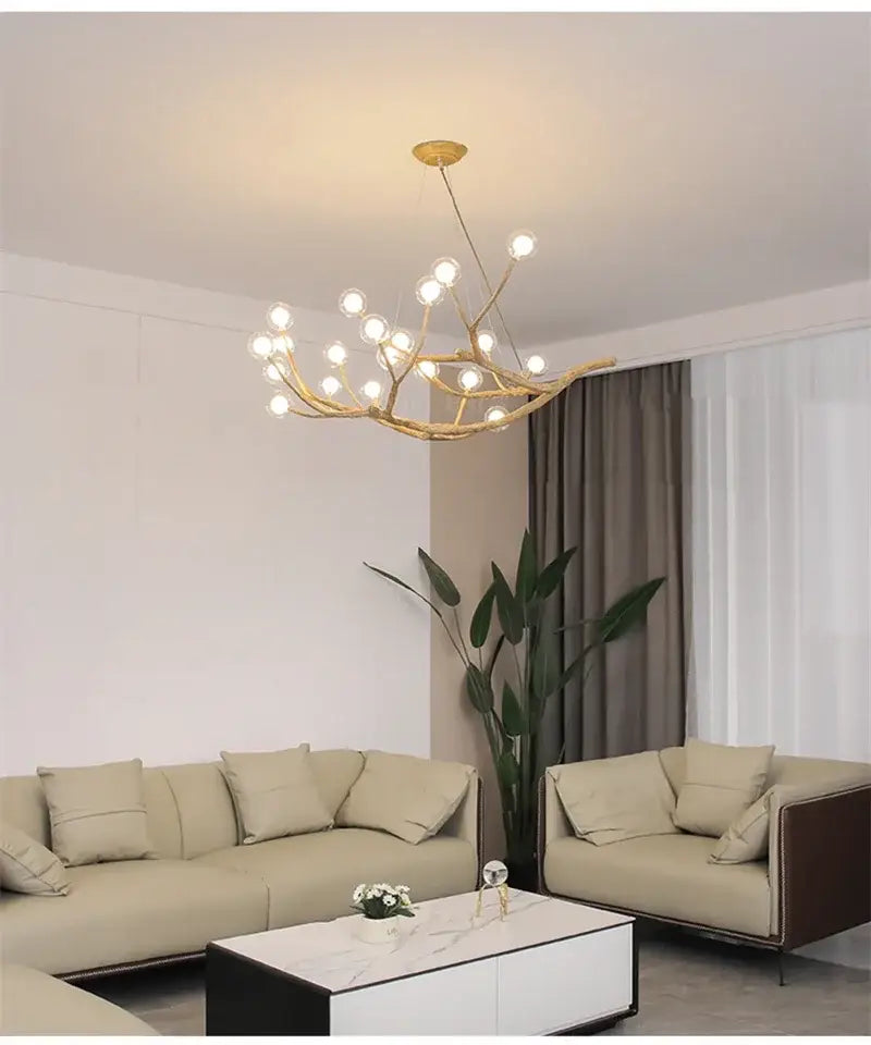 Gold-toned iron tree branch chandelier with antler design and multiple spherical bulbs by DecorBites™