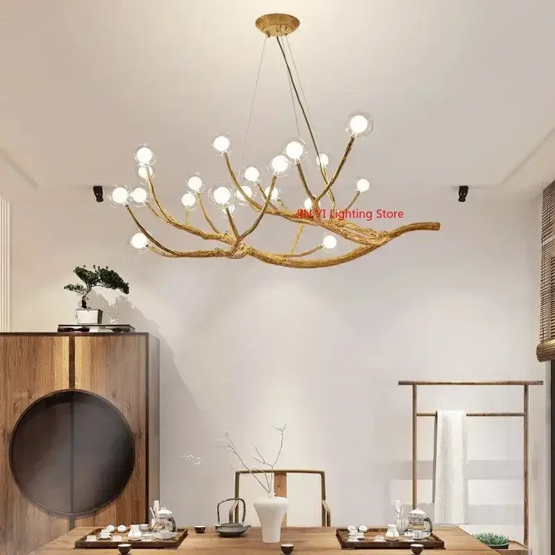Golden iron tree branch chandelier with multiple spherical bulbs from decorbites simulation bubble design