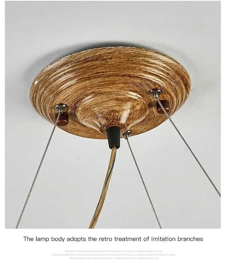Rustic bronze iron tree branch pendant lamp with textured design and three hanging cords by decorbites
