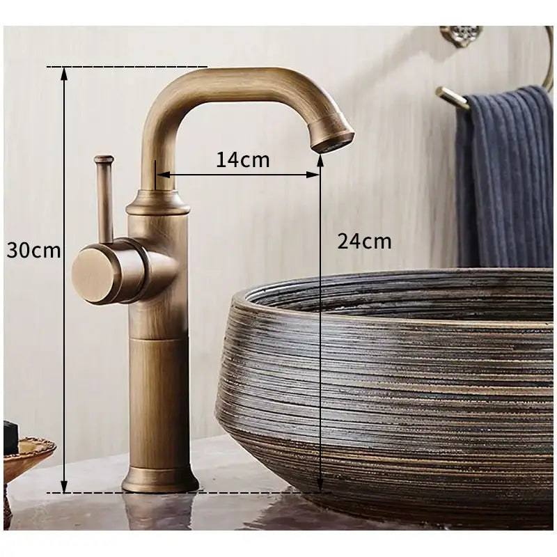 DecorBites single handle antique brass bathroom faucet with curved spout and cylindrical base in brass bathroom finish