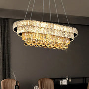 DecorBites™ sleek chrome LED light fixture with a crystal shade and golden crystals suspended by metallic chains inches wide